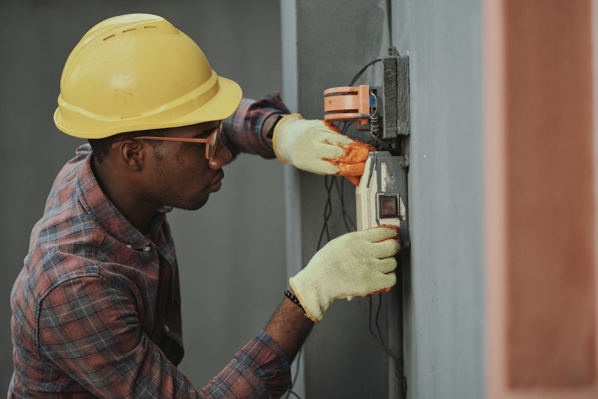 Electrical technician inspecting switchgear and power distribution equipment